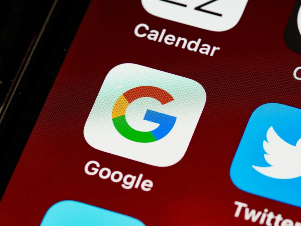 Google app icon on a phone home screen, for an article on setting a Google Ads budget