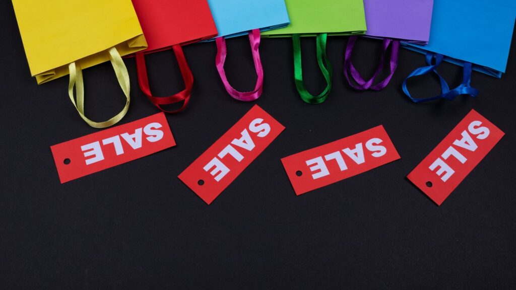 Colourful shopping bags with red sale tags, illustrating Black Friday offers