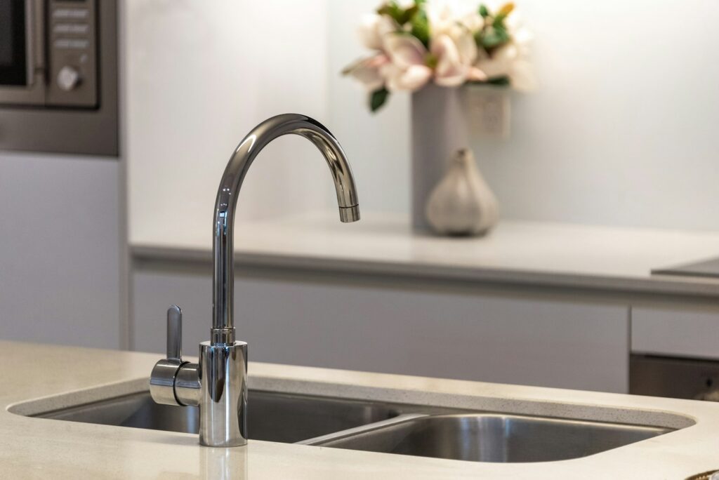 Chrome kitchen tap over a stone benchtop, from a Facebook ads case study for a water filtration company